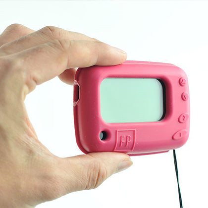 A hand holding a red bleeper pager