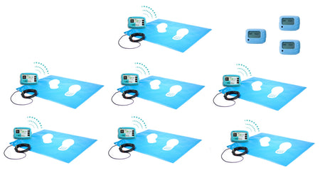 Several wireless floor pressure mats positioned next to multiple wireless control boxes