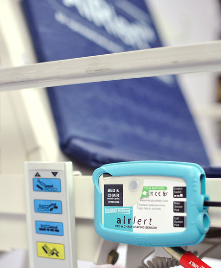 Airlert control box attached to the side of an upright bed