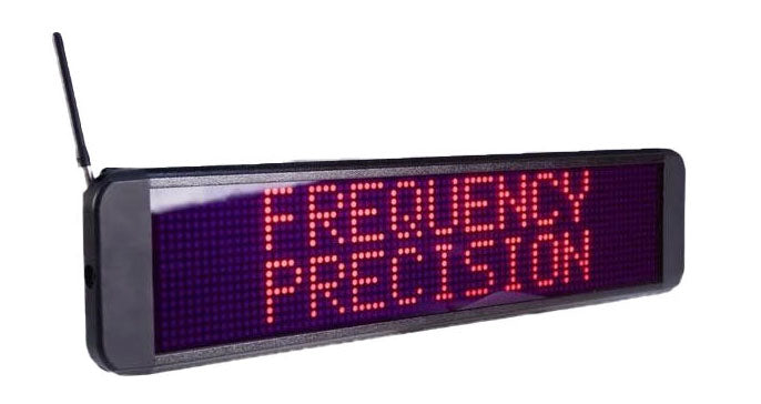 A red LED sign displaying &quot;Frequency Precision&quot;