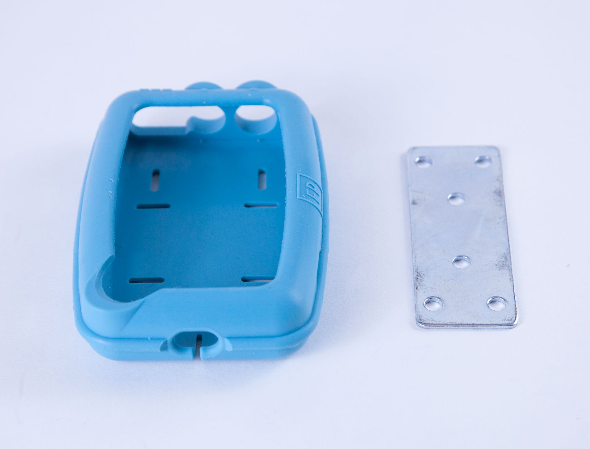 Blue rubber case besides silver wall plate