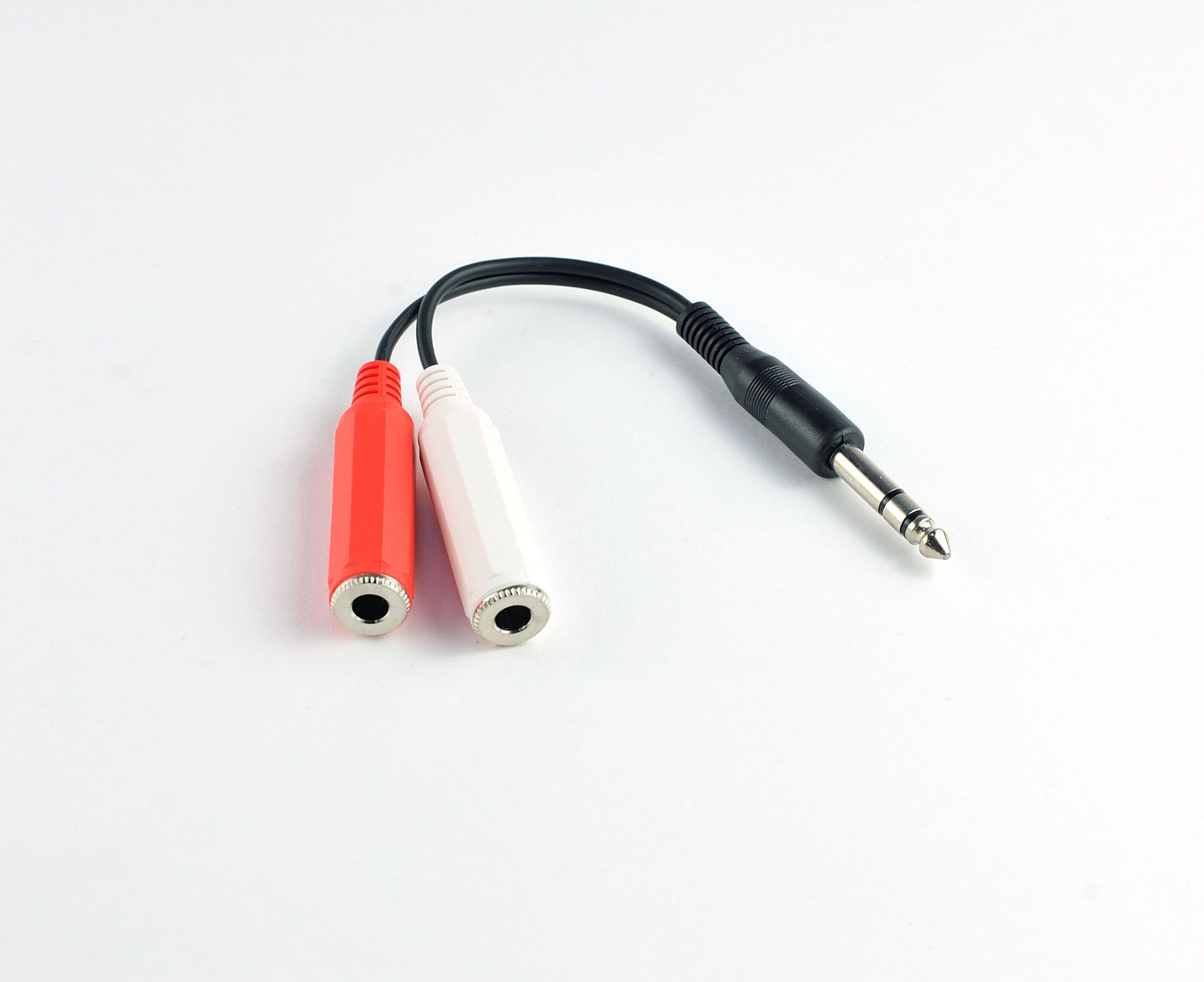 A pair of red and white wires connected on a plain surface