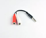 A pair of red and white wires connected on a plain surface